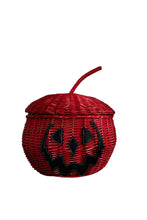 Load image into Gallery viewer, A red woven pumpkin-shaped basket with a black jack-o'-lantern face on white background