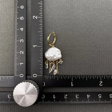 Load image into Gallery viewer, Pearl earring with gold accents on a ruler for scale