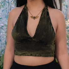 Load image into Gallery viewer, Person wearing a green velvet halter top with a patterned background