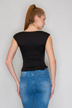 Load image into Gallery viewer, Woman wearing a black top and blue jeans against a plain background