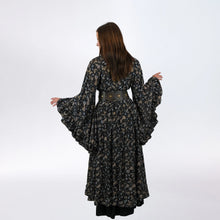 Load image into Gallery viewer, Woman wearing a long, dark floral dress on a white background