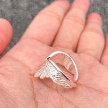 Load image into Gallery viewer, Silver wing-shaped ring on a hand