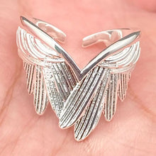 Load image into Gallery viewer, Silver wing-shaped ring on a hand