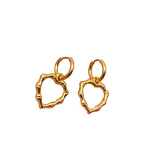 Load image into Gallery viewer, Gold hoop earrings held in a hand against a neutral background