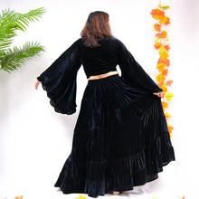 Load image into Gallery viewer, Person wearing a black velvet outfit with long sleeves and a tiered skirt, standing against a white background with decorative elements.