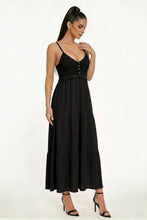 Load image into Gallery viewer, Woman wearing a black dress with buttons on a white background