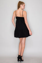Load image into Gallery viewer, Woman wearing a black dress against a plain background