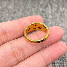 Load image into Gallery viewer, Gold ring with a unique design held in a hand against a gray background