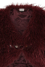 Load image into Gallery viewer, Close-up of a burgundy shaggy coat with a brand label.