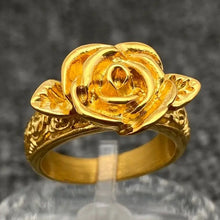 Load image into Gallery viewer, Gold rose-shaped ring on a gray background