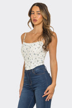Load image into Gallery viewer, Woman wearing a white floral top and blue jeans on a plain background