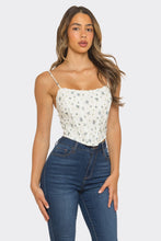 Load image into Gallery viewer, Woman wearing a white floral top and blue jeans on a plain background