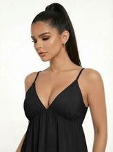 Load image into Gallery viewer, Woman wearing a black dress against a white background