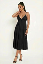 Load image into Gallery viewer, Woman wearing a black dress against a white background