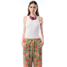 Load image into Gallery viewer, Woman wearing a white tank top and floral pants on a white background