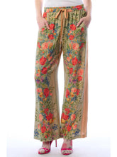 Load image into Gallery viewer, Floral patterned pants worn by a person on a white background