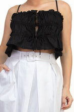 Load image into Gallery viewer, Black ruffled top worn by a person with white pants on a plain background