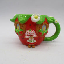 Load image into Gallery viewer, Colorful mug shaped like a strawberry house with a character on a white background