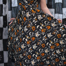 Load image into Gallery viewer, Dress with Halloween-themed pattern featuring cats, bats, and flowers on a black background.
