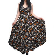 Woman wearing a floral dress with a pattern of cats and moons against a white background.
