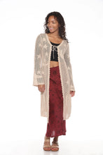 Load image into Gallery viewer, Woman wearing a long beige cardigan over a black top and red skirt on a white background

