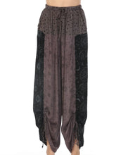 Load image into Gallery viewer, Bohemian-style harem pants in a gray and black colorway, featuring a sheer dotted waistband, patterned panels, and gathered cuffed hems, shown on a model against a white background.
