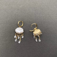 Load image into Gallery viewer, Pair of gold earrings with pearl-like stones on a gray background
