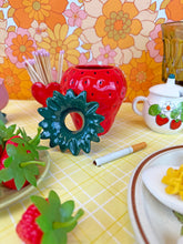 Load image into Gallery viewer, Decorative items on a table with a colorful floral wallpaper background
