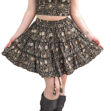 Load image into Gallery viewer, Person wearing a patterned dress standing against a white wall.
