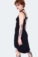Load image into Gallery viewer, Woman wearing a black dress with cut-out straps on a white background
