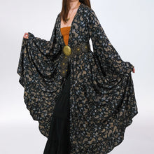 Load image into Gallery viewer, Woman wearing a dark floral patterned kimono-style garment on a white background
