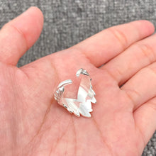 Load image into Gallery viewer, Silver ring with leaf design on a hand against a gray background
