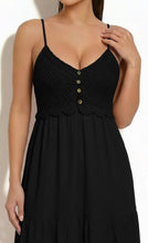Load image into Gallery viewer, Black dress with scalloped edges and button details on a white background

