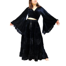 Load image into Gallery viewer, Woman wearing a black velvet outfit with wide sleeves against a white background with decorative elements.
