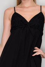 Load image into Gallery viewer, Black dress with thin straps worn by a person against a neutral background
