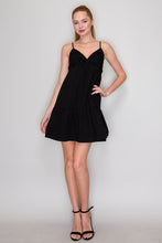 Load image into Gallery viewer, Woman wearing a black dress against a plain background
