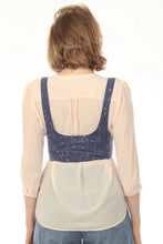 Load image into Gallery viewer, A woman viewed from behind wearing a cream-colored blouse with a navy blue printed undergarment-style back panel and blue jeans, against a plain white background.
