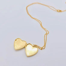 Load image into Gallery viewer, Gold heart-shaped locket on a light gray background
