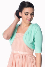 Load image into Gallery viewer, Woman wearing a light green cardigan over a pink dress on a white background
