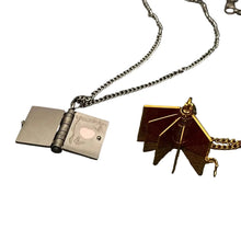 Load image into Gallery viewer, Two necklaces with unique pendants on a dark textured surface
