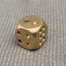 Load image into Gallery viewer, Gold dice on a textured gray surface
