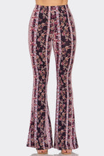 Load image into Gallery viewer, Flared pants with a floral pattern on a white background
