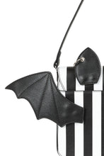 Load image into Gallery viewer, Black bat-shaped strap accessory on a clear handbag with black and white striped pattern.

