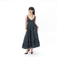 Load image into Gallery viewer, Woman wearing a black floral patterned dress on a white background
