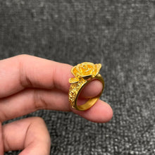 Load image into Gallery viewer, Gold ring with rose design held in a hand against a gray background
