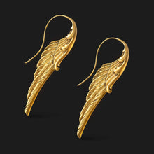 Load image into Gallery viewer, Gold wing-shaped earrings on a black background
