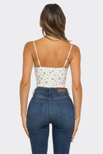 Load image into Gallery viewer, Woman wearing a white floral top and blue jeans on a plain background
