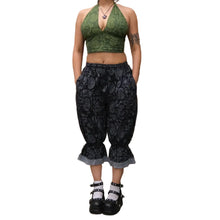 Load image into Gallery viewer, Person wearing a green patterned top and black floral pants against a white background.
