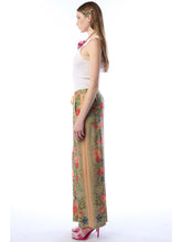 Load image into Gallery viewer, Woman wearing a floral dress with a white background
