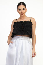 Load image into Gallery viewer, Woman wearing a black ruffled top and white pants on a white background
